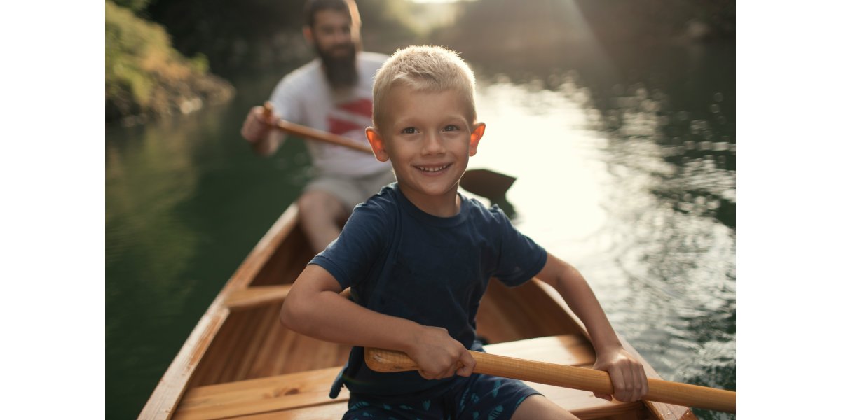 Man and boy rowing a canoe